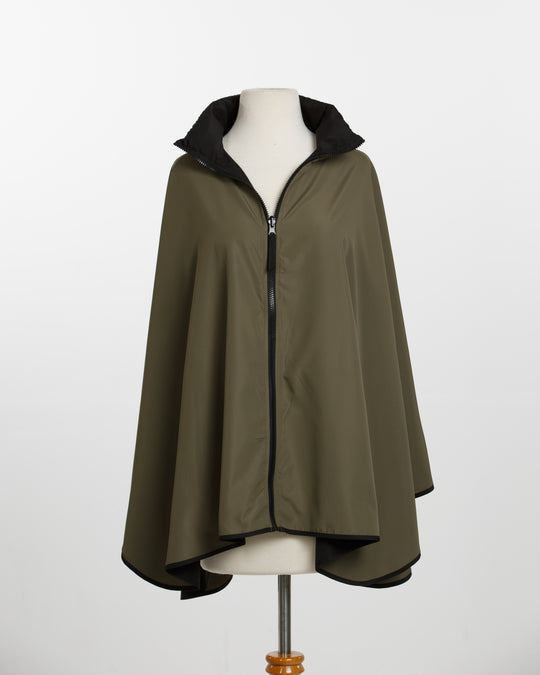 Green cape on a mannequin against a white background